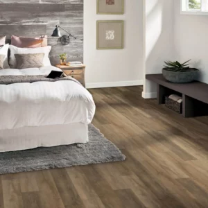 Wood-look luxury vinyl plank flooring in a bedroom | Coleman's Flooring & Blinds